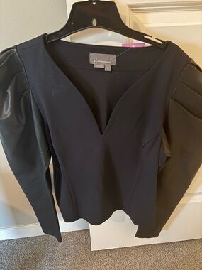 Anthropologie black top,sleeves are faux leather, worn twice. Size M